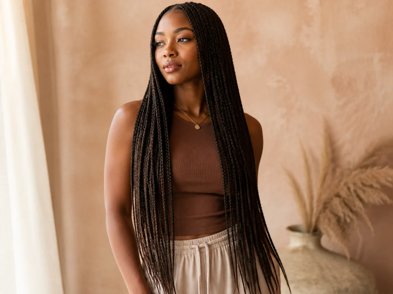 Neat waist-length medium knotless braids