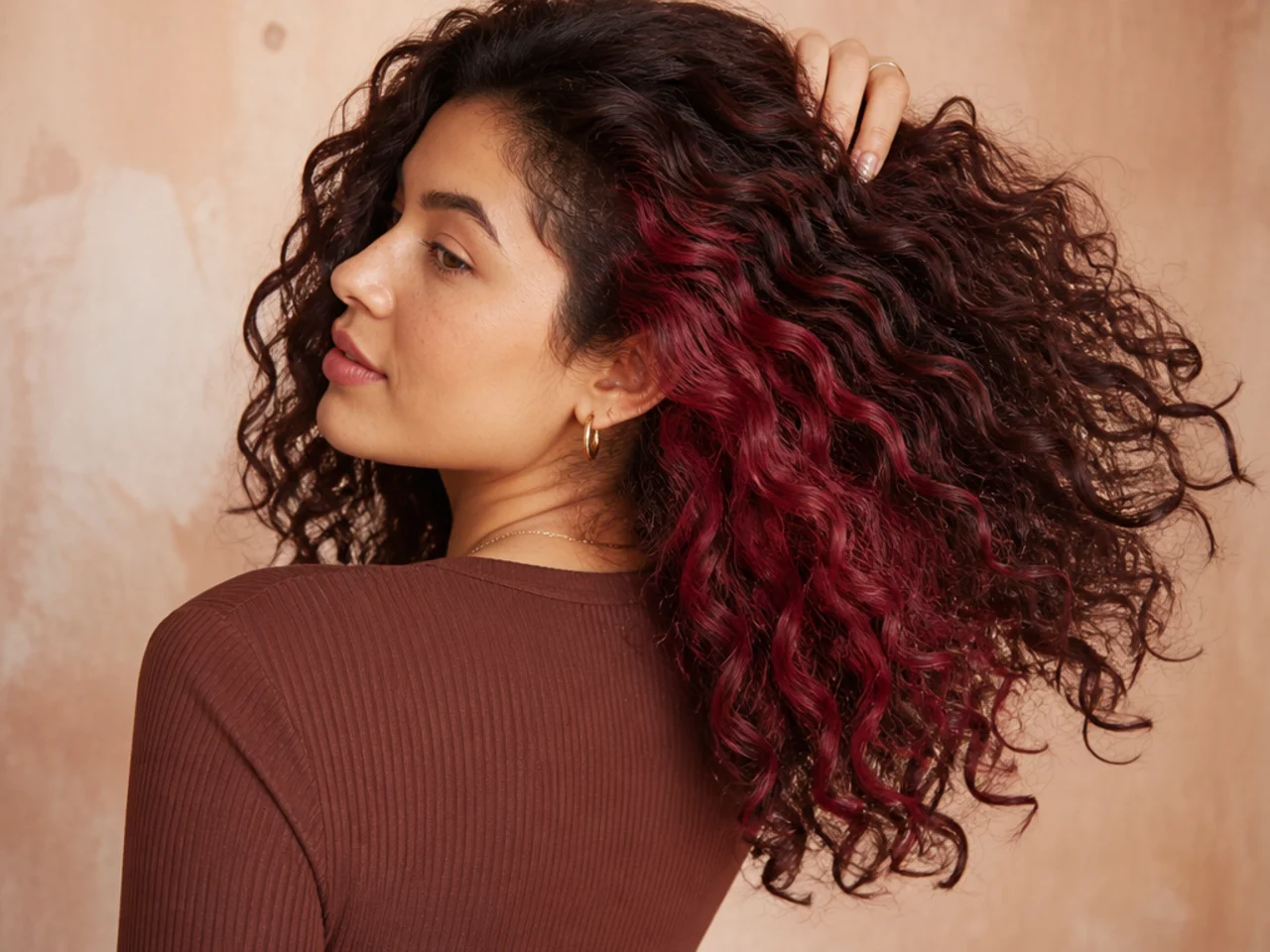 A vivid panel on curly dark hair