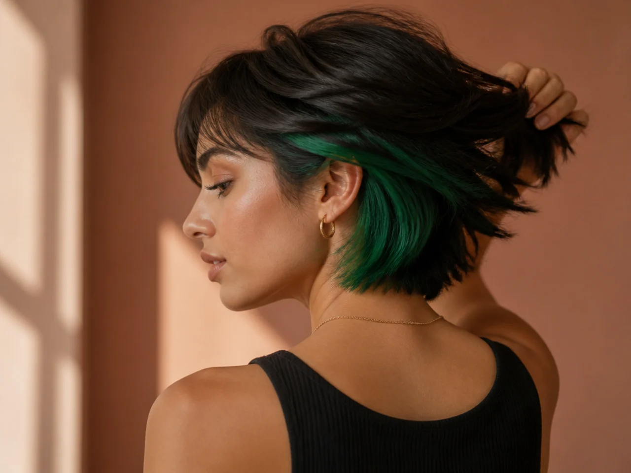 An emerald panel under dark short hair