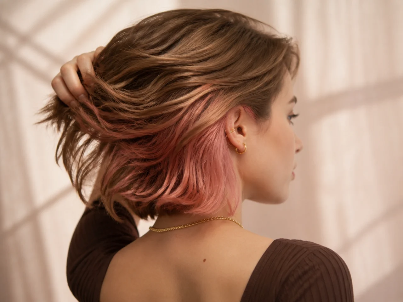 A rose gold panel under light brown short hair