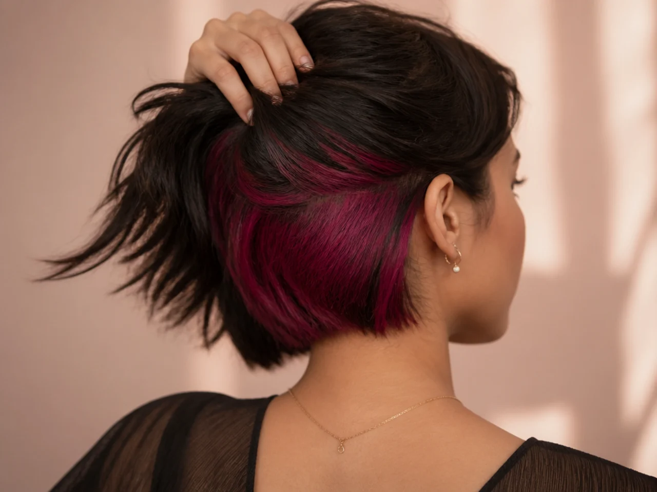 A magenta panel under dark brown short hair