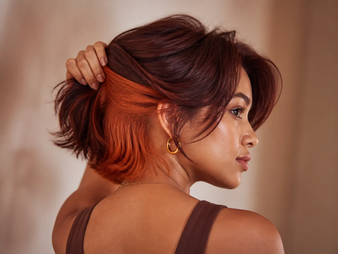 A copper panel under auburn short hair