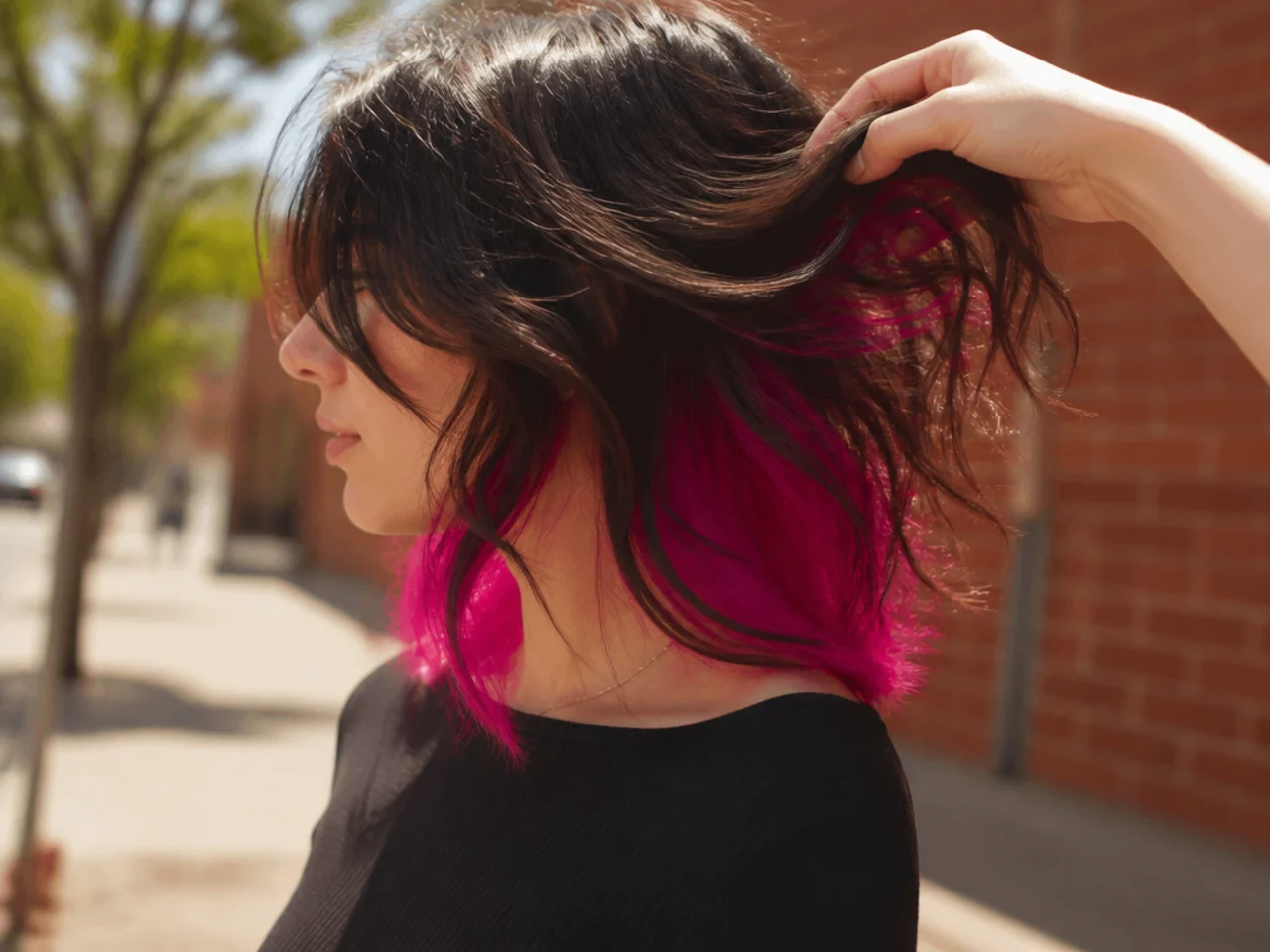 A neon pink under layer glowing in bright outdoor light