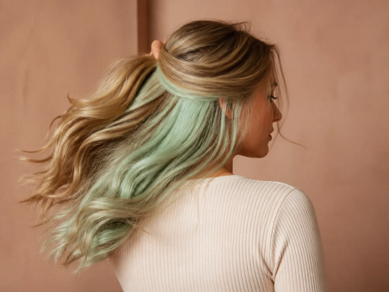 A mint green panel on blonde hair