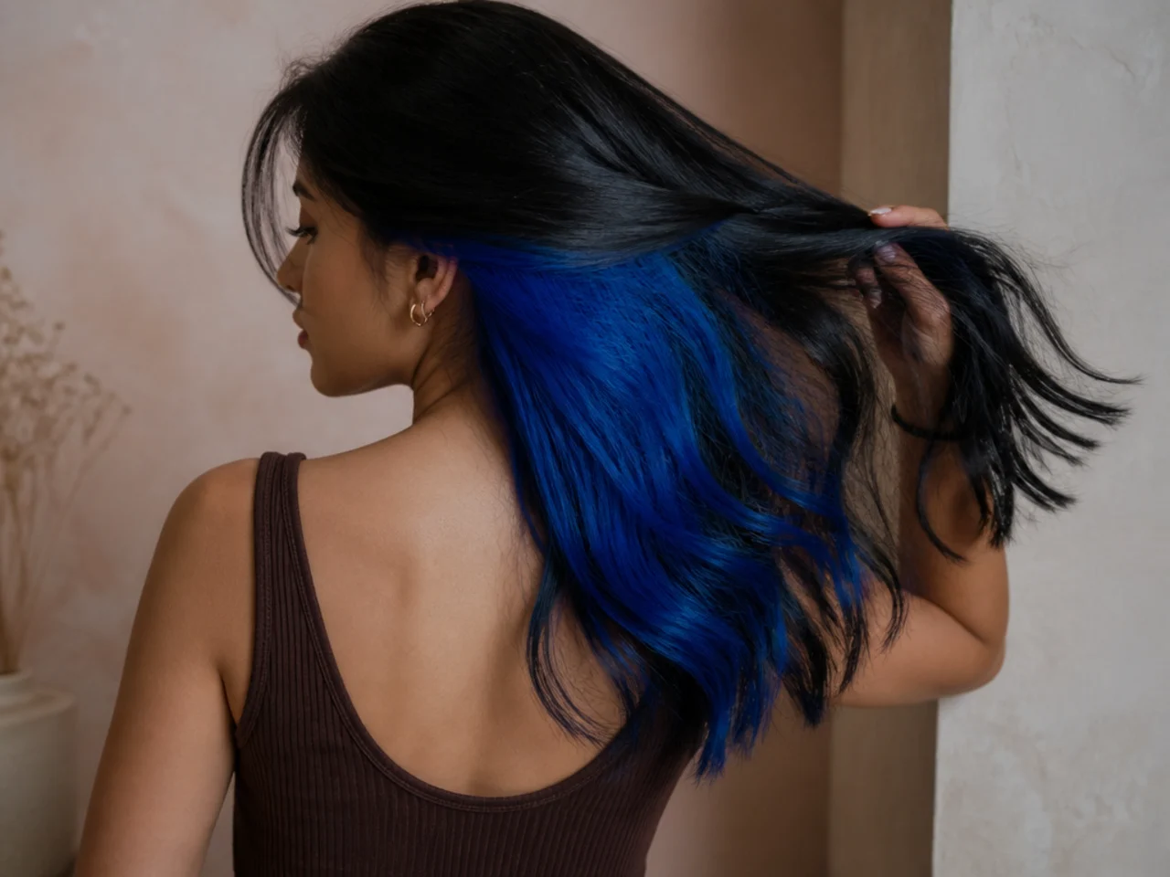 An electric blue panel under black hair