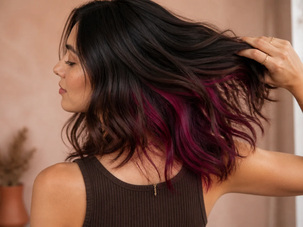 A magenta panel under dark brown hair