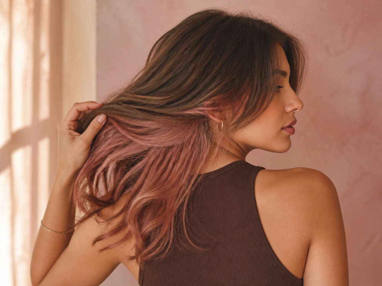 A rose gold panel under light brown hair