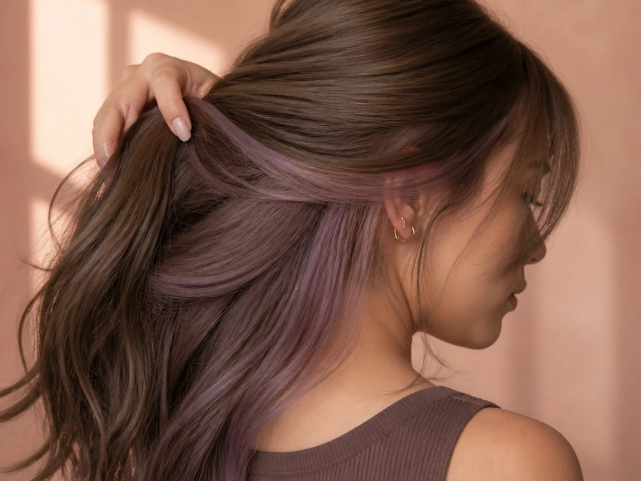 A mauve panel under light brown hair