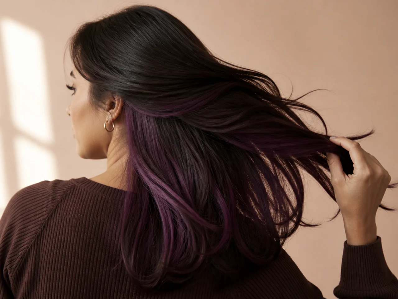 A plum panel under dark brown hair