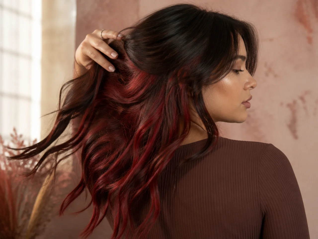 A cherry red panel under dark brown hair