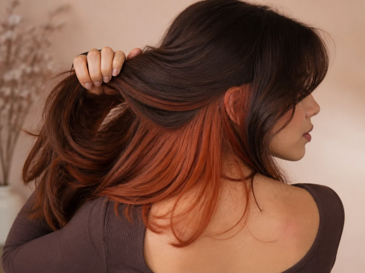 A copper panel under auburn hair