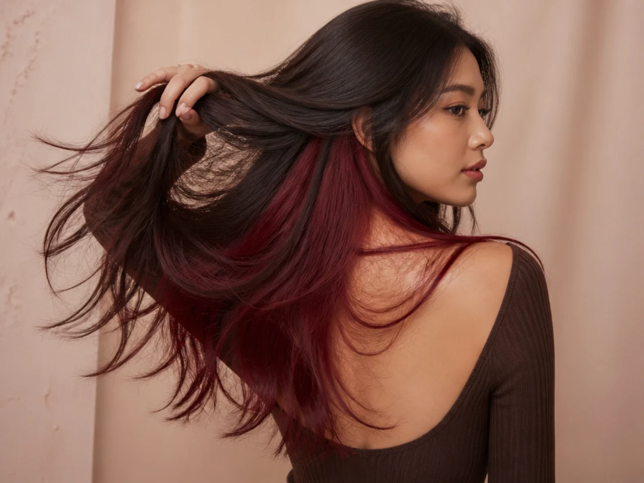A wine red panel under brunette hair