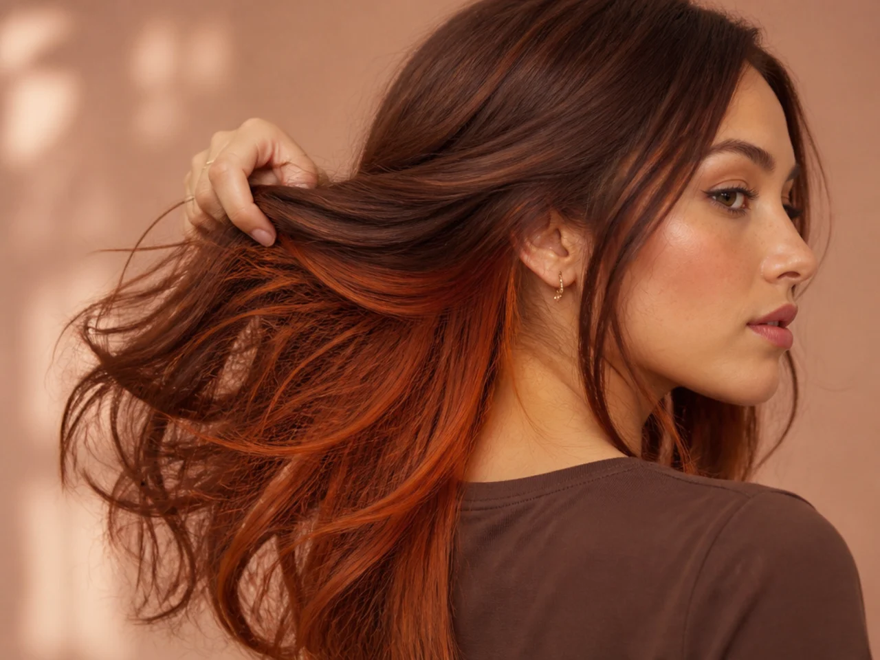 A soft copper panel under auburn hair