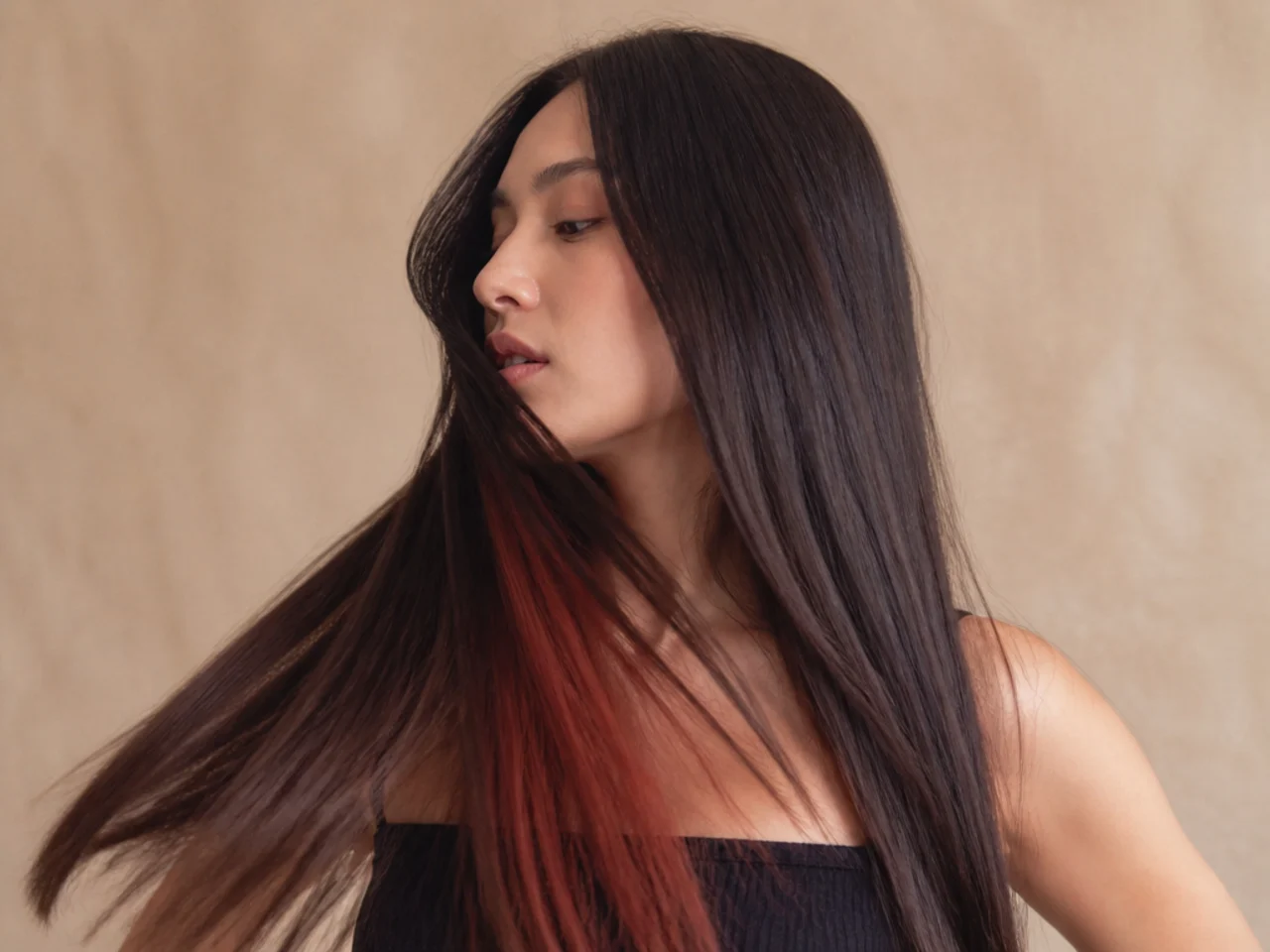 Sleek straight hair hiding a coloured panel until it moves