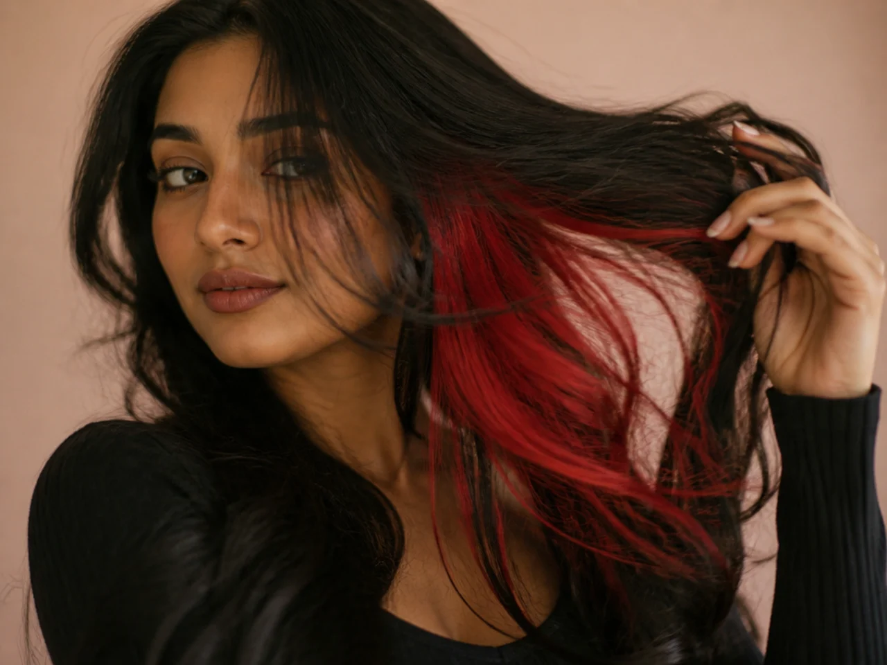 A bright scarlet red panel revealed under dark hair in motion