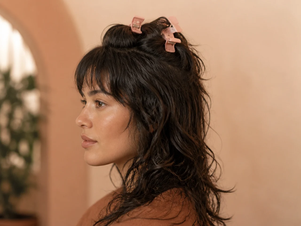 Root clips set at the crown of a shag while the hair dries