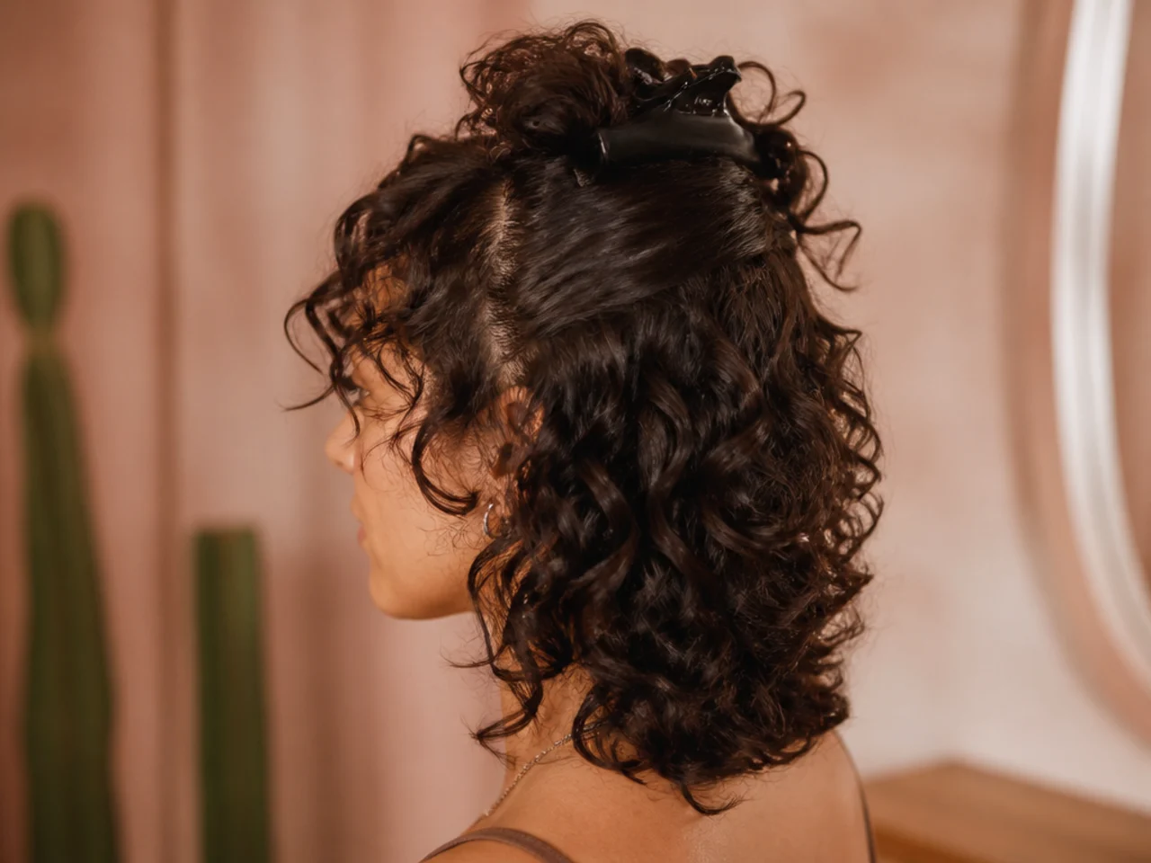 The back sections of a curly shag finished while the front sections remain clipped up