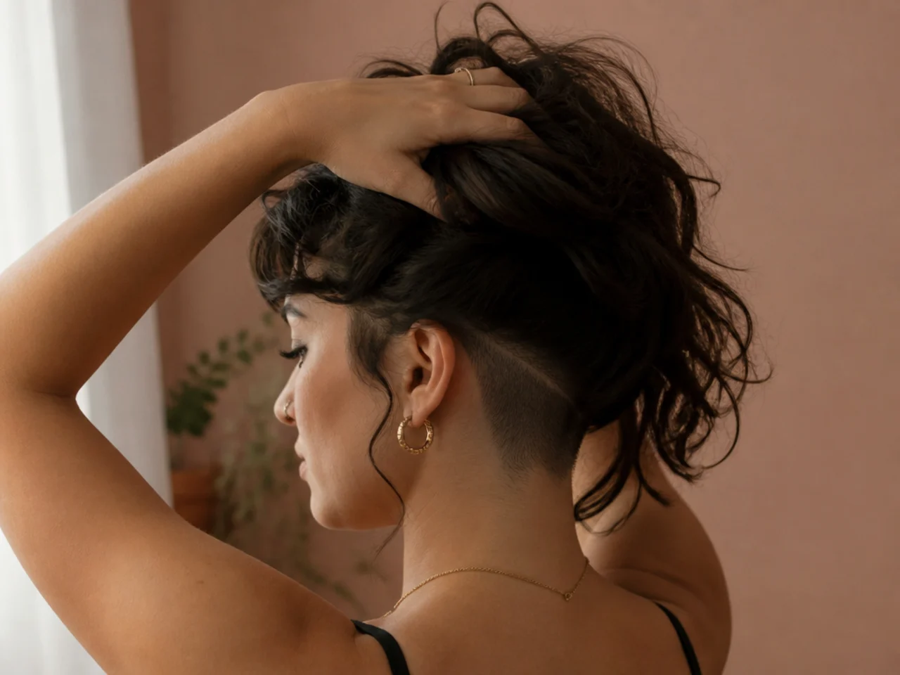 A wavy shag lifted at the nape to show a hidden undercut underneath