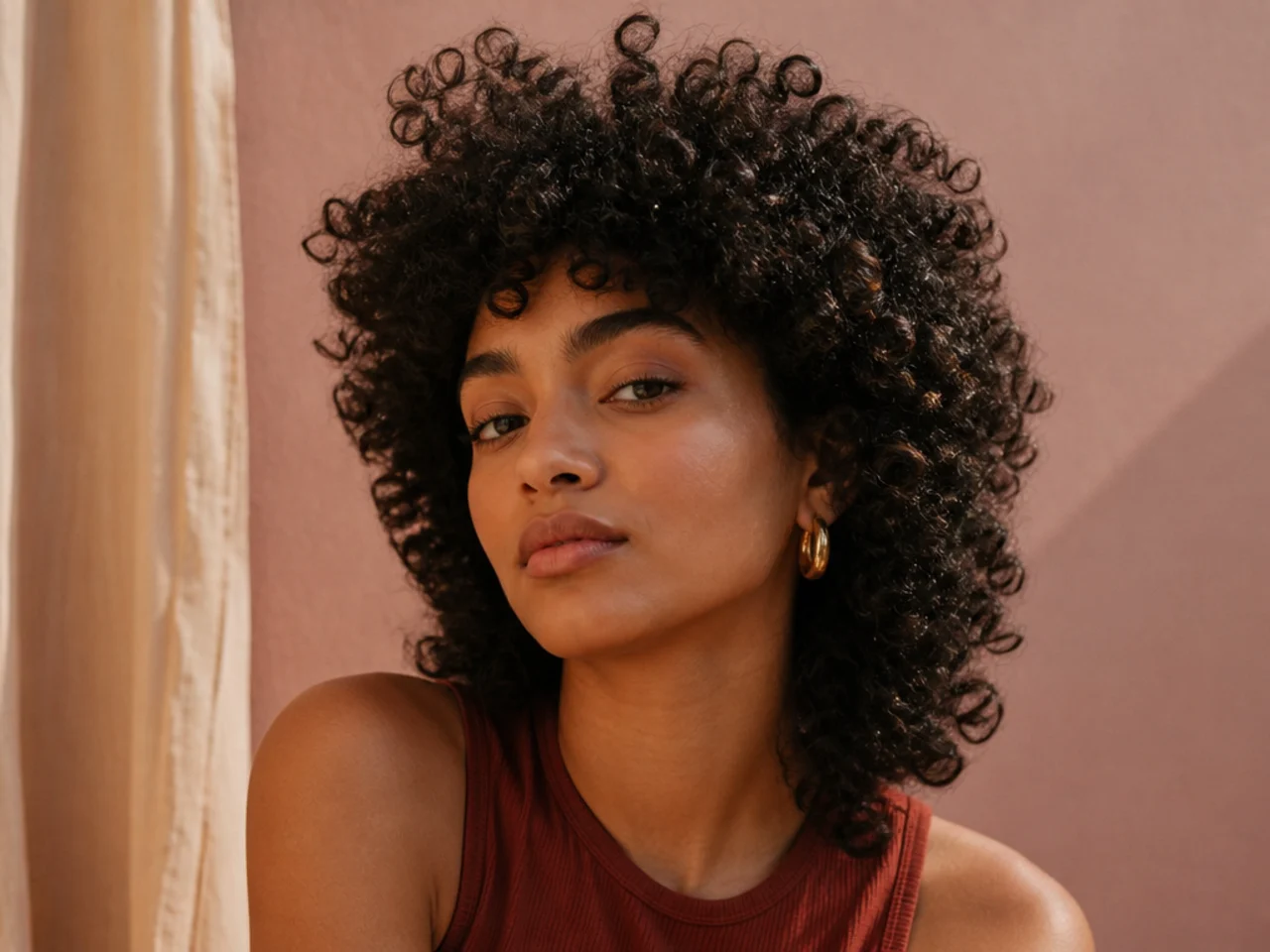 A coily textured shag with a short fringe standing up at the front