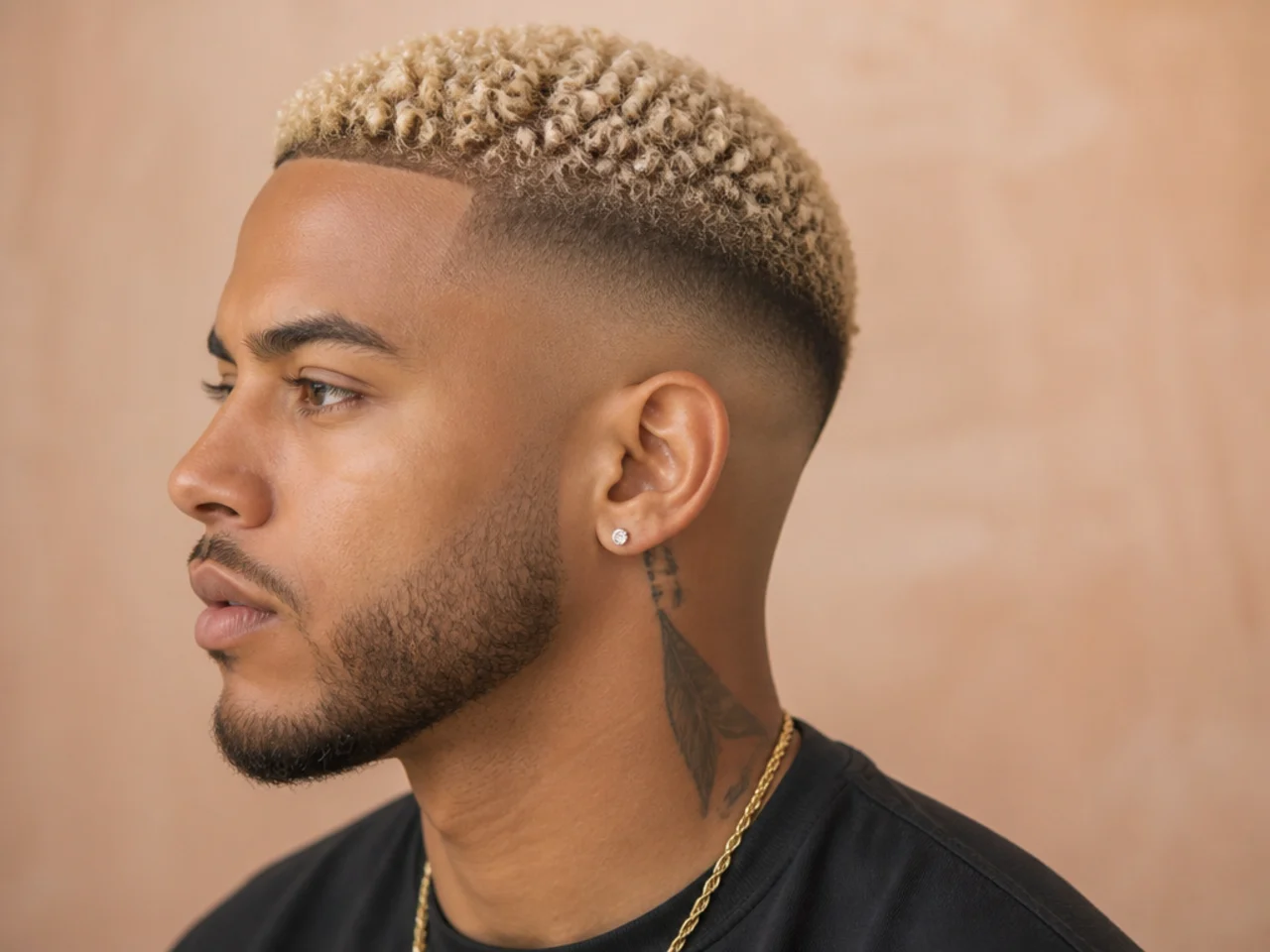 Short bleached-blonde textured top over dark natural roots with a clean low taper fade at the sides on a Black man
