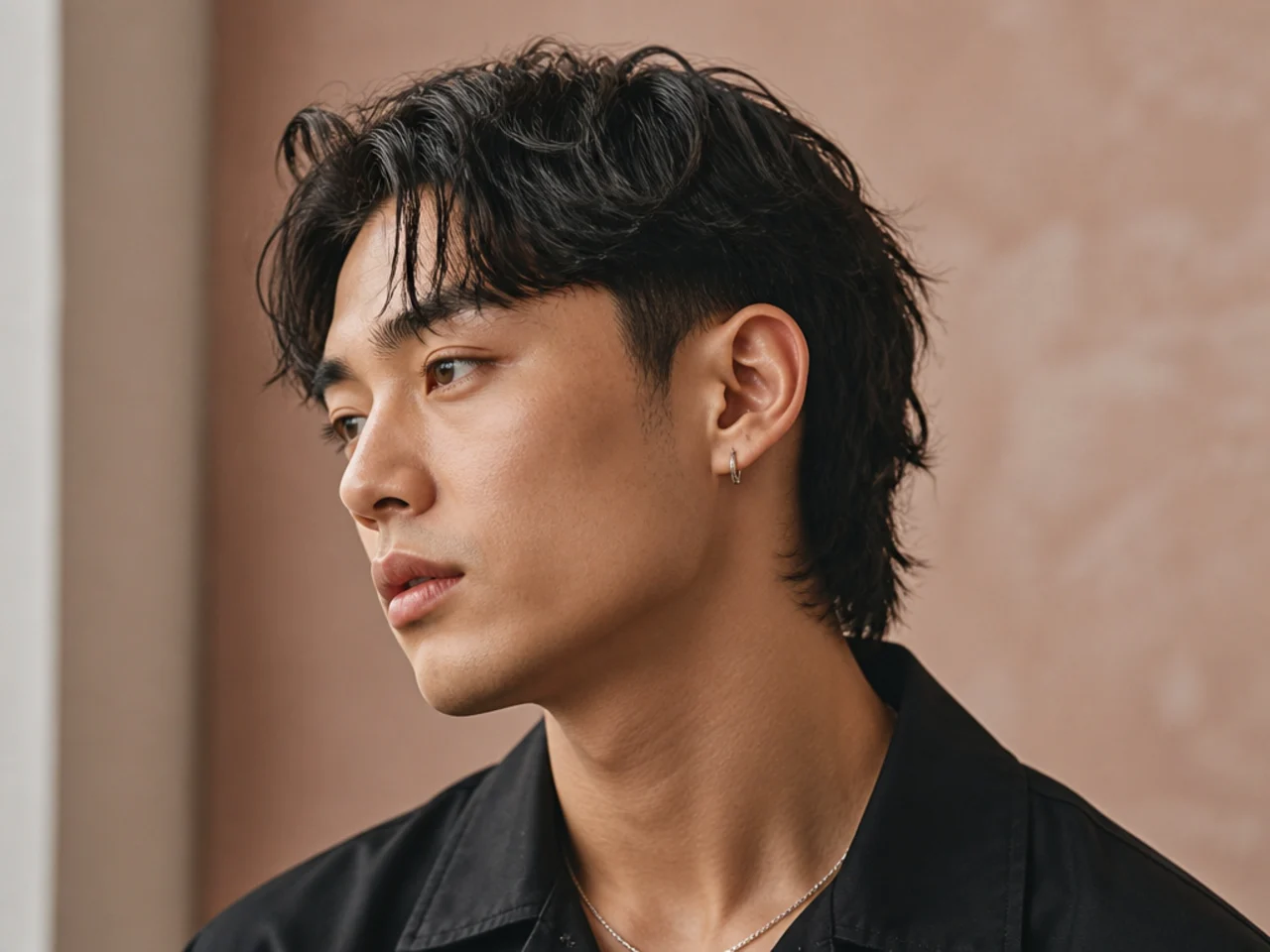 Short mullet with comma-shaped fringe curling inward at the forehead
