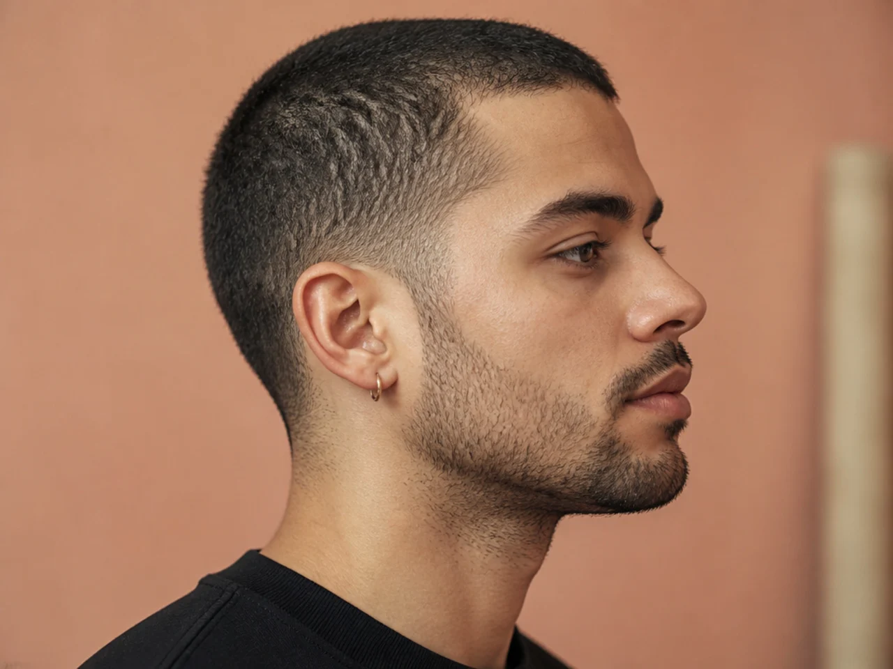 Grown-out buzz cut on a young man showing 1.5 inch all-over length and soft taper on straight dark brown hair