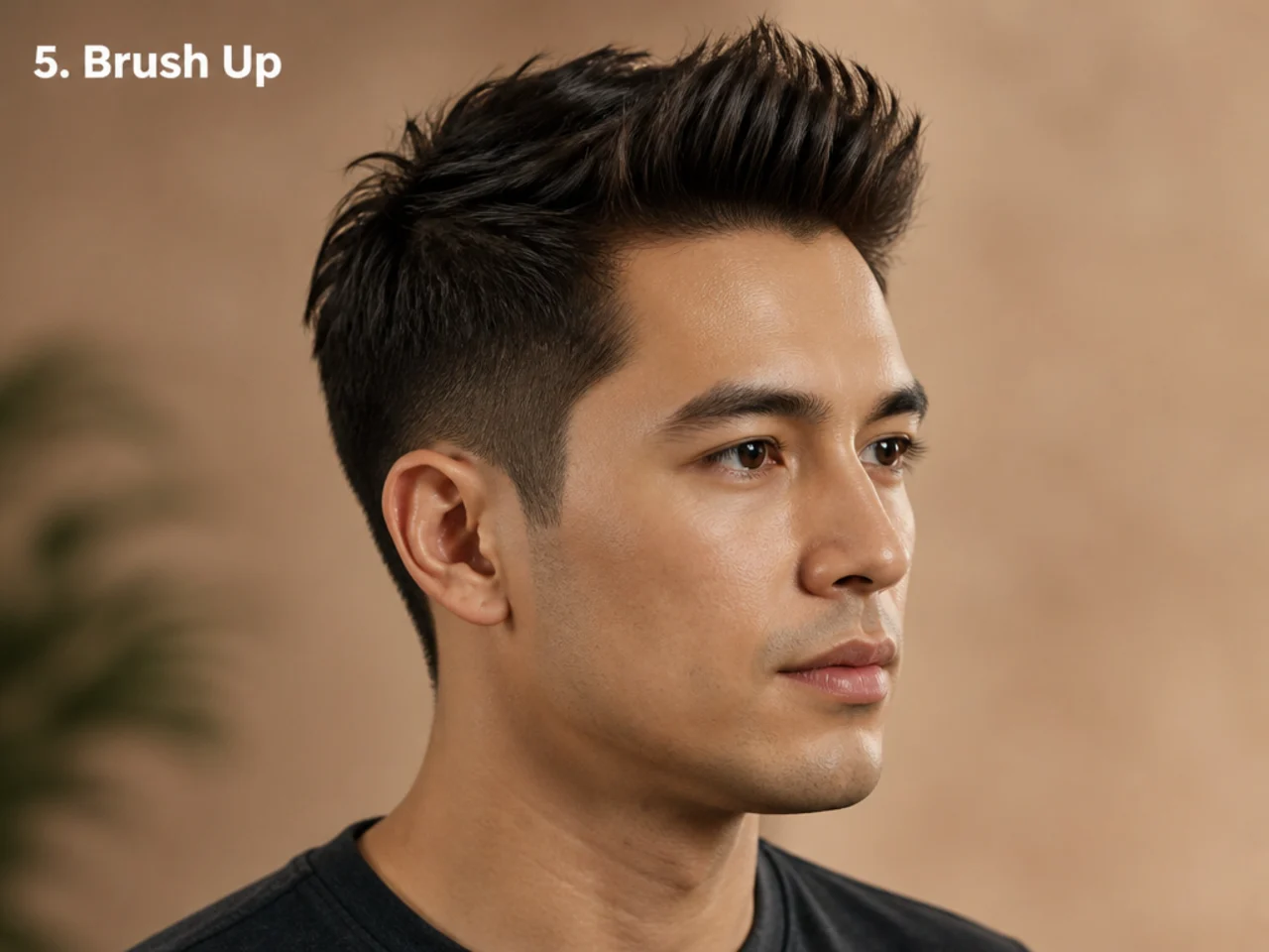 Short brush up on a young man with 2 inch pushed-up top and low fade on wavy brown hair