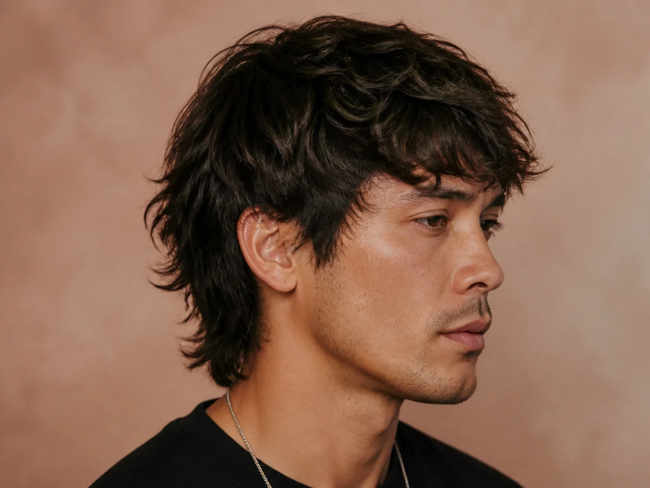 Styling products and tools for a short wolf cut laid out — matte clay, sea-salt spray, blow dryer