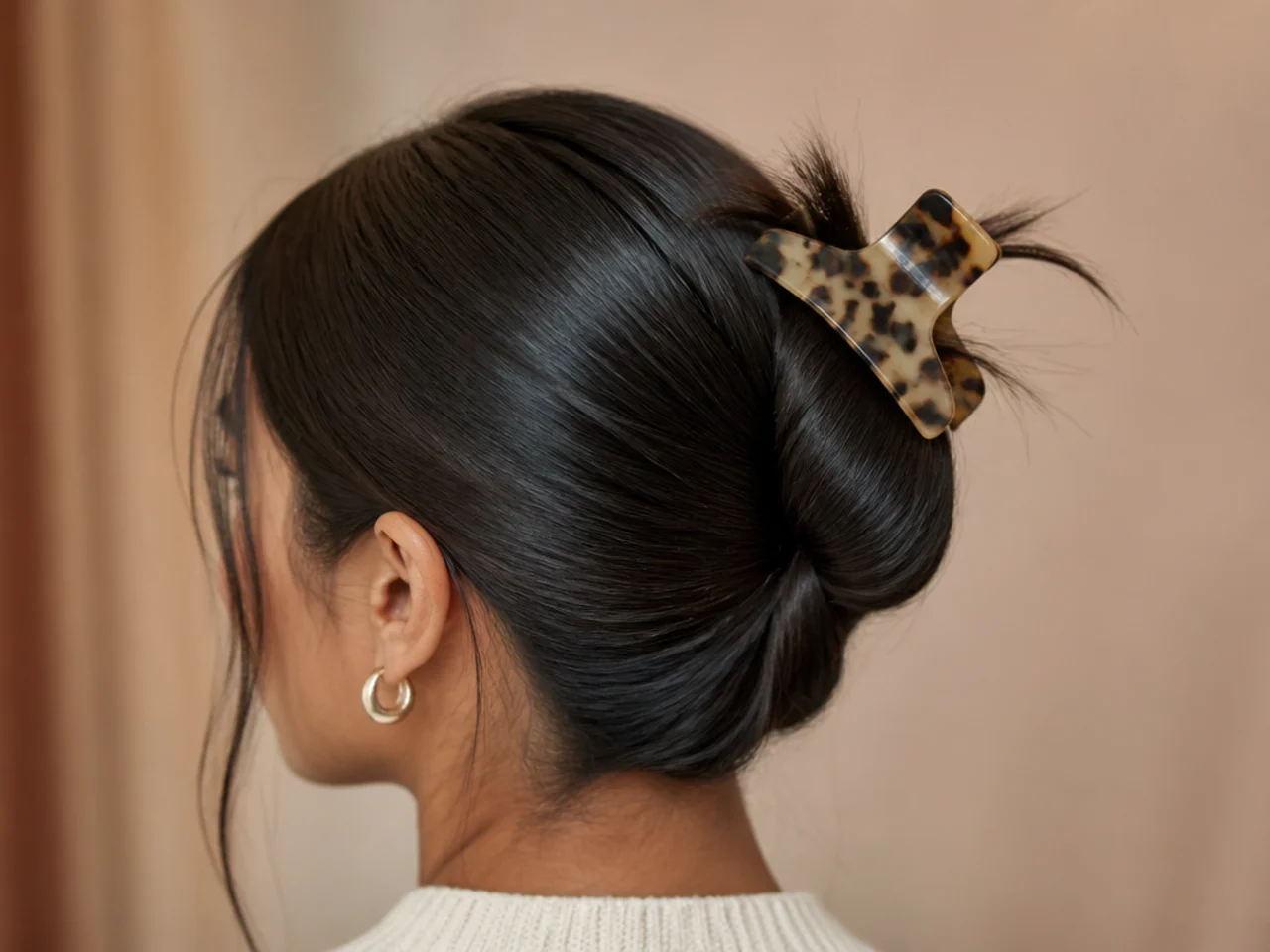 A clip sliding out of over-smoothed slippery hair
