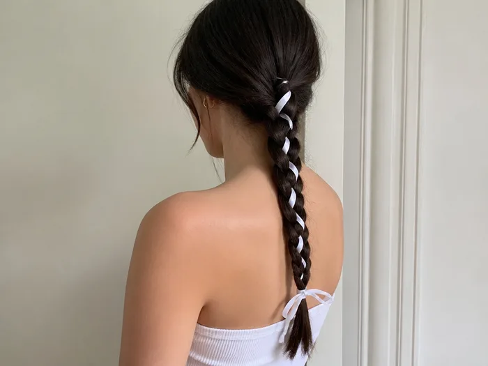 Skeleton braid Halloween hairstyle with white braid over dark hair