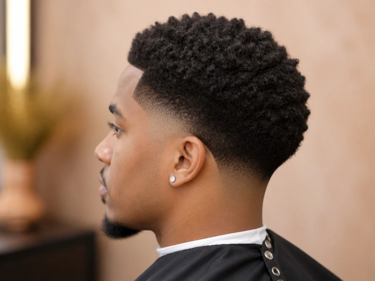 Low taper fade on coily 4C hair with a defined perimeter