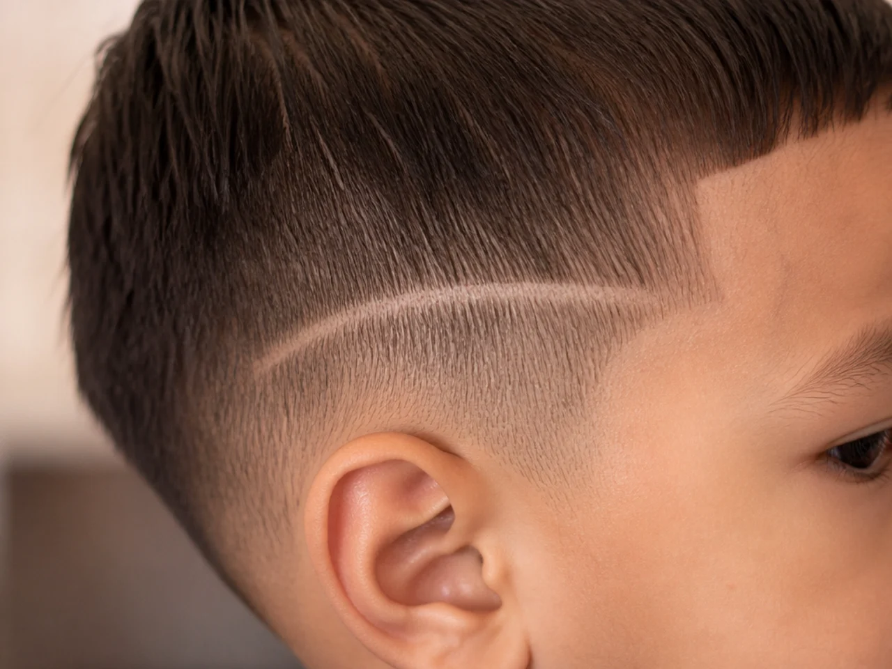 A shaved line above a toddler's ear growing out after a week