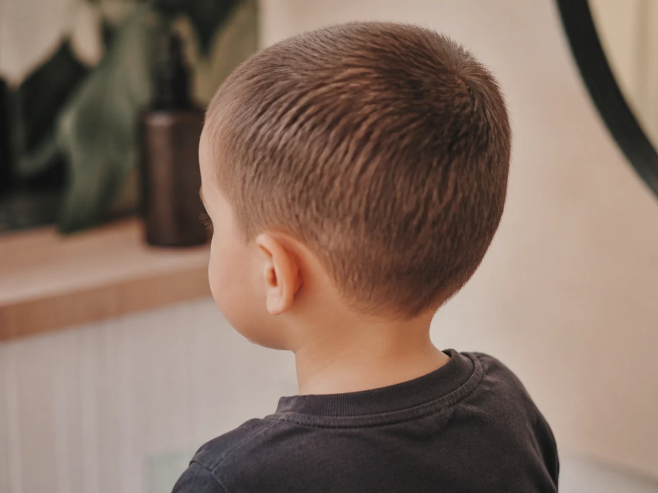 A toddler with an even short haircut all over