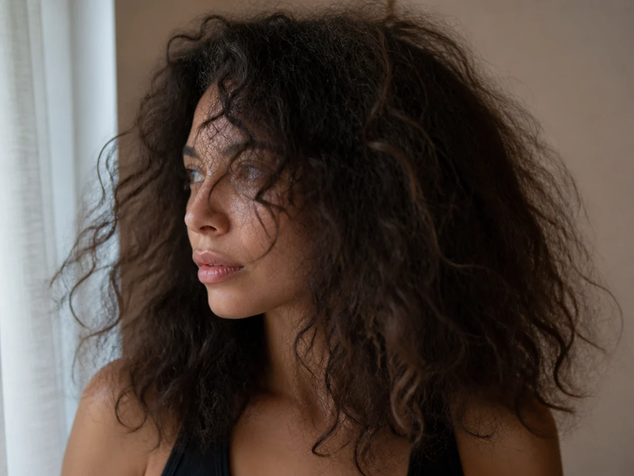 Frizzy curly hair with a broken up layer edge and no definition
