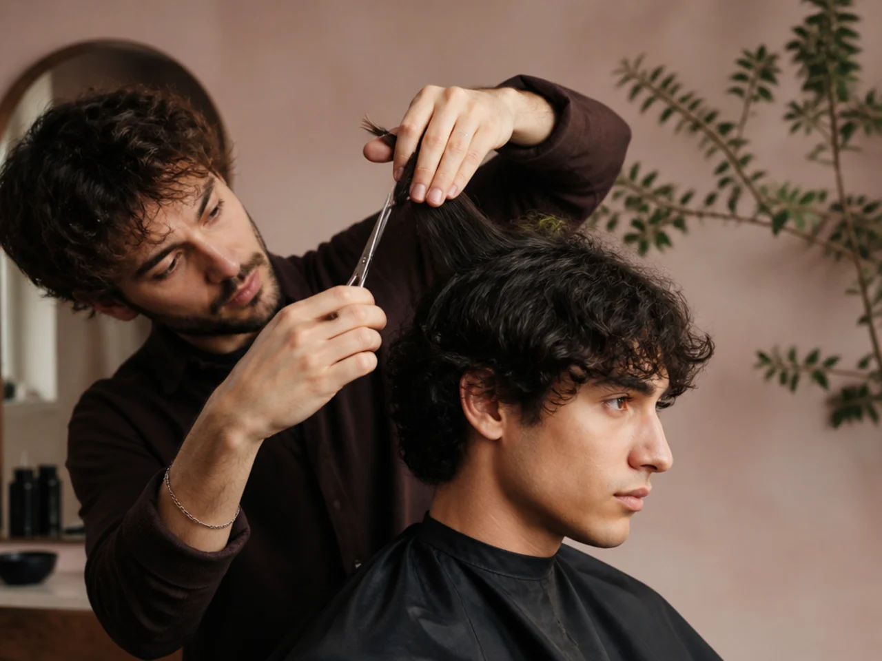 Wavy mens hair being dry cut section by section