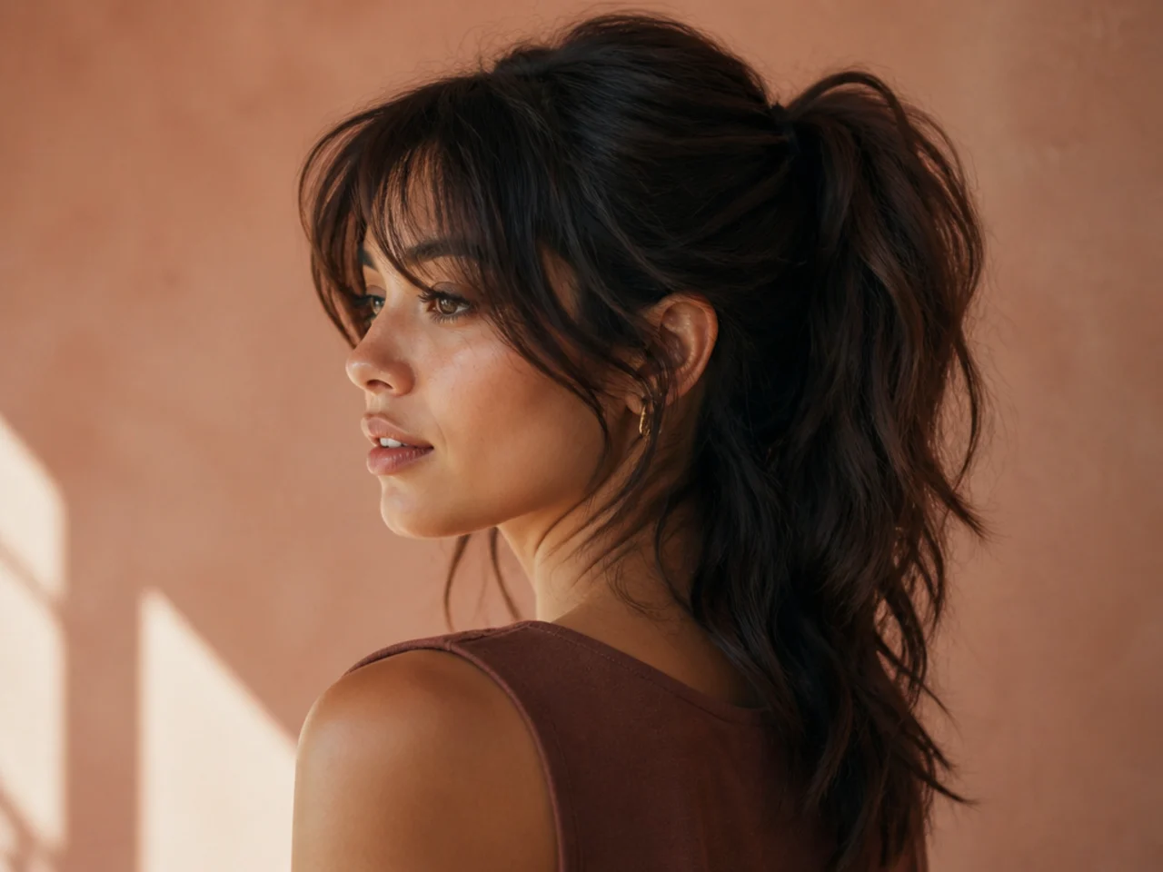 Three-quarter view of a long wolf cut tied into a soft ponytail