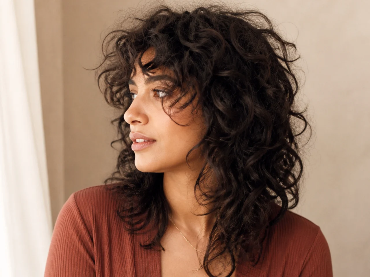 Defined curls in a wolf cut with widely spaced supportive layers