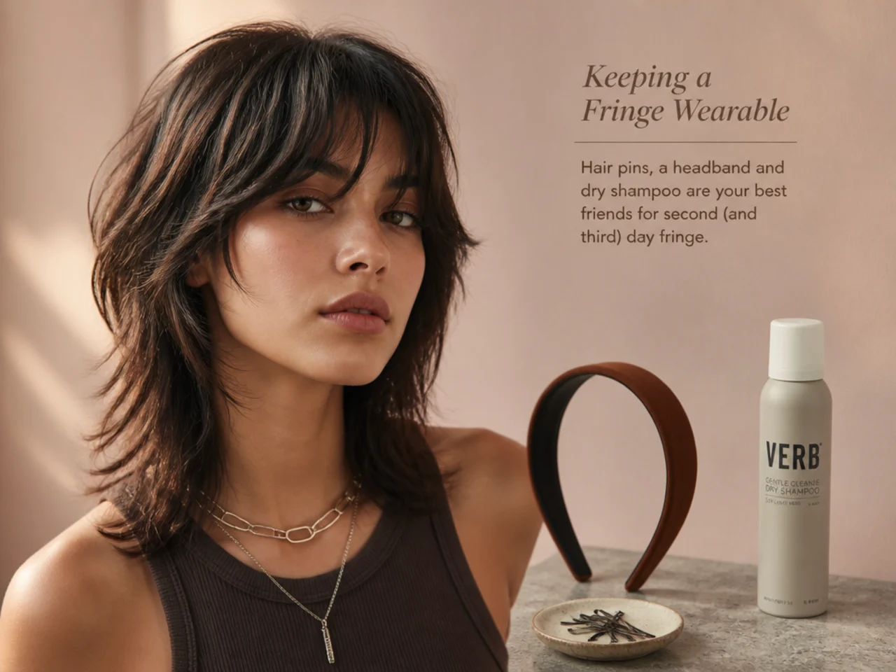 Hair pins, a headband and dry shampoo laid out for fringe upkeep