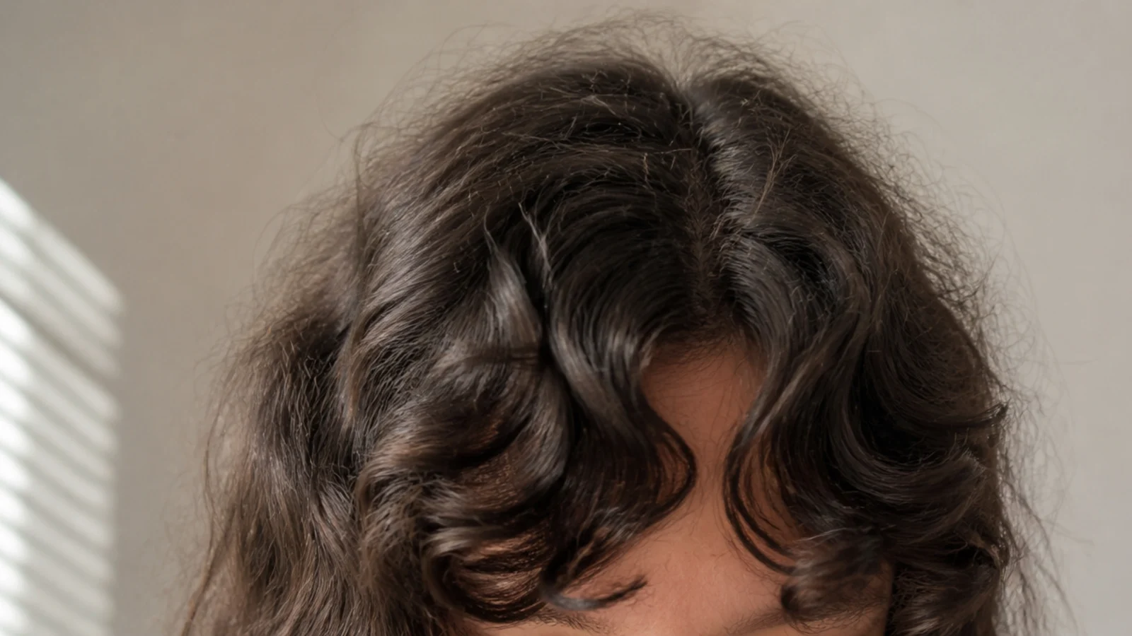 Soft curly bangs split either side of the forehead