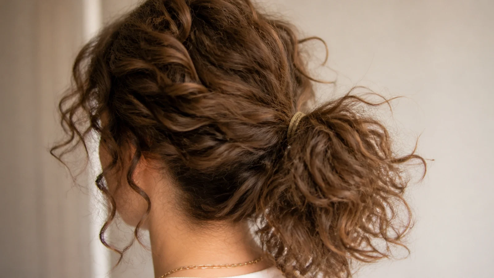 A curly ponytail with a soft rounded halo across the top of the head