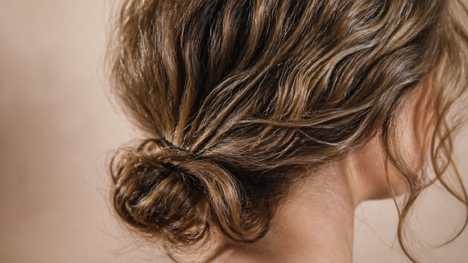 A soft low bun sitting at the nape of the neck