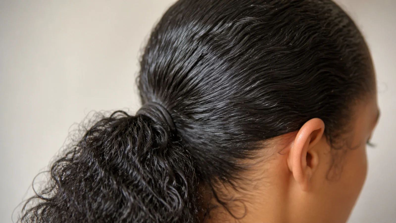 A sleek slicked back ponytail with a smooth hairline