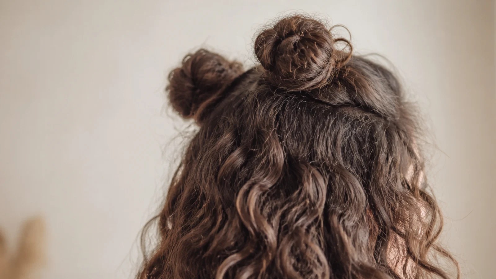 Two small buns set high with the rest of the hair worn down