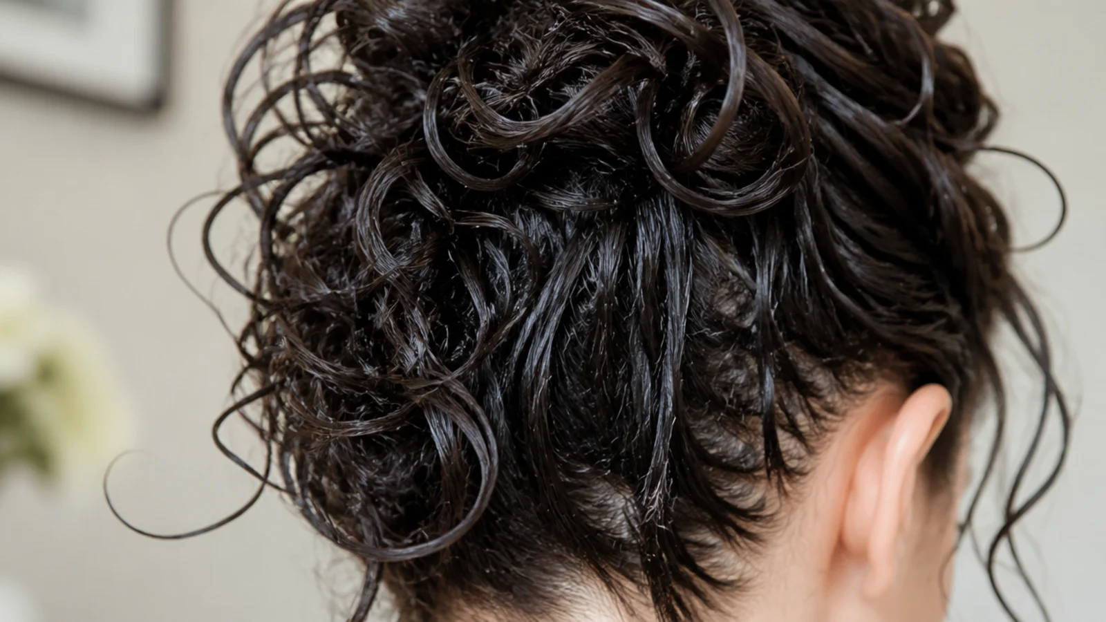 Gel being scrunched upward into wet sections of hair