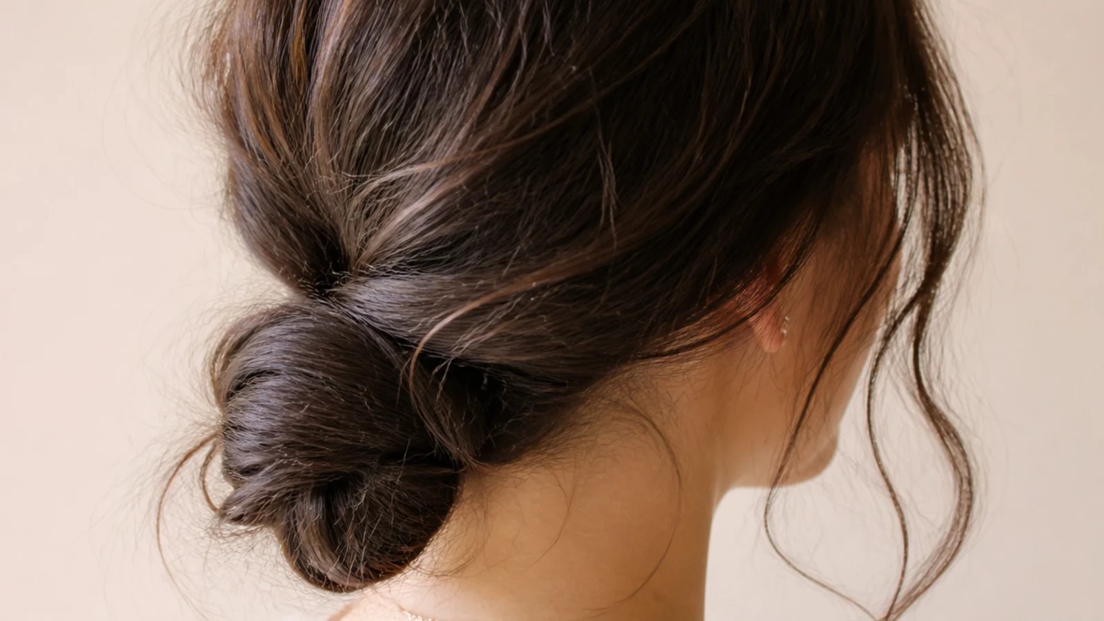 Third day hair gathered into a soft low bun