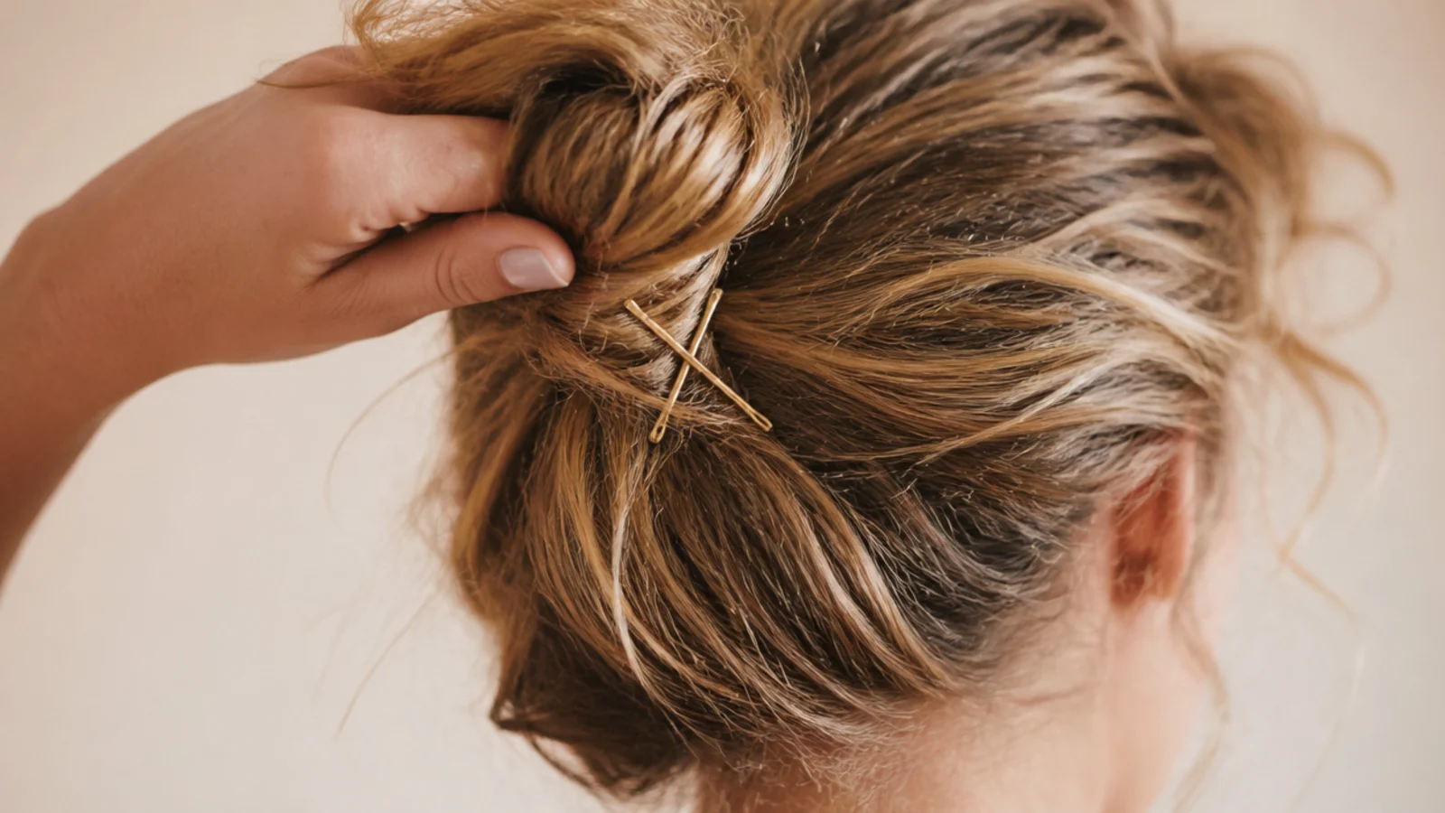 A loose high bun with soft pieces falling around the temples