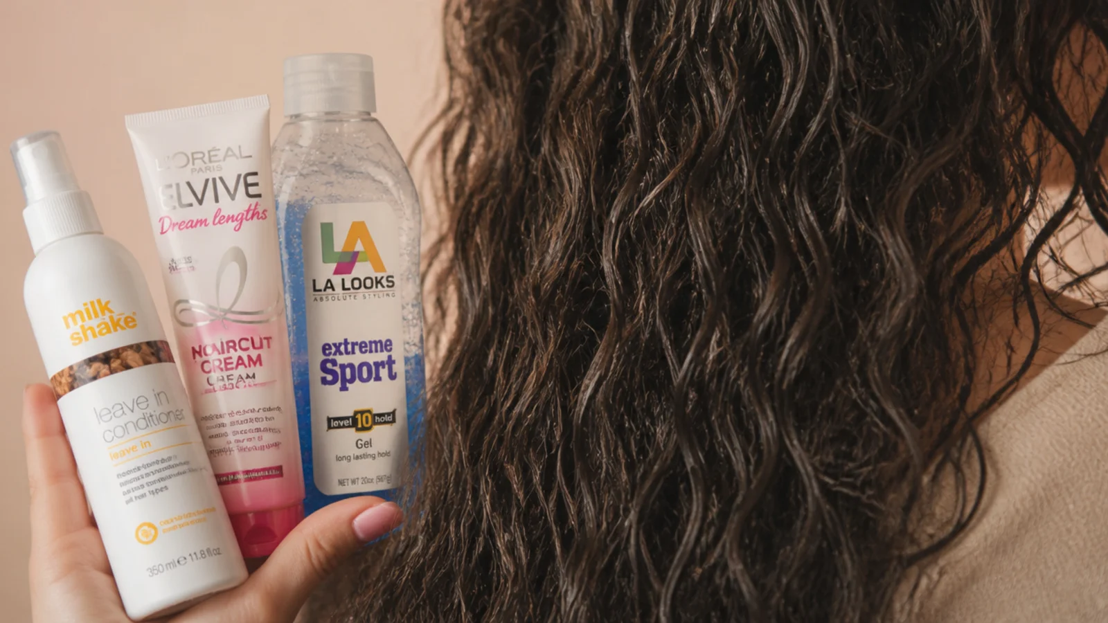 Three plain product tubs lined up beside a section of damp hair