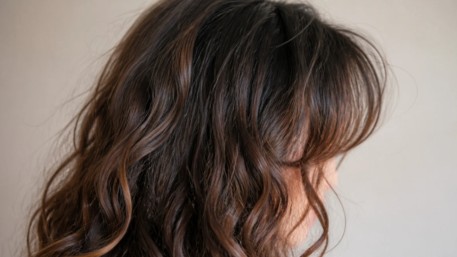 Curtain bangs parted in the centre and sweeping back at cheekbone height