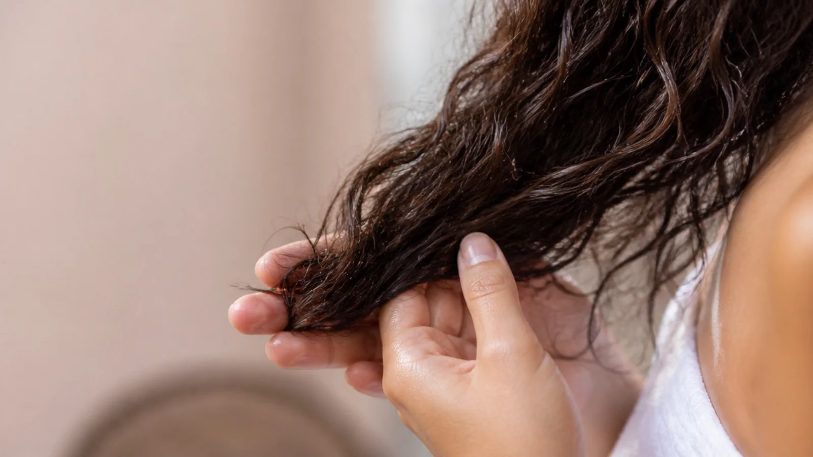 Oil being smoothed through the last few inches of hair