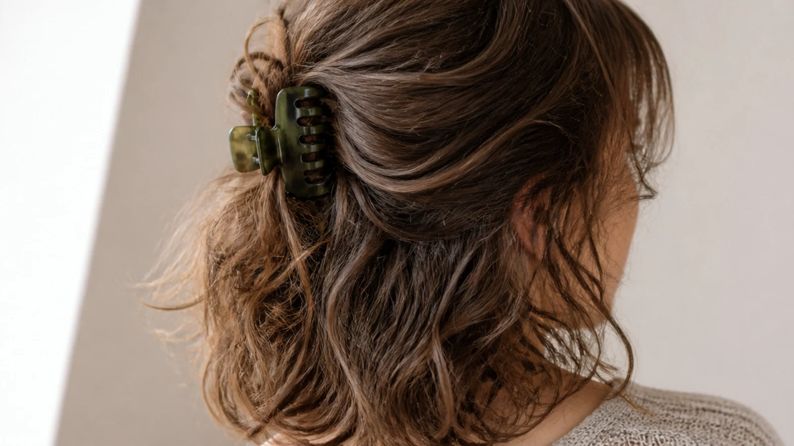 A large claw clip holding the top half of textured hair back